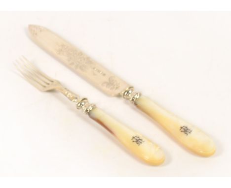 A Victorian hallmarked silver bladed and mother of pearl handled large knife and fork, both blades with foliate engraved deco