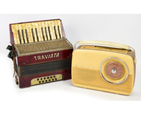 A 1960's Bush radio, serial no. 462/45558, in beige and brown, with MW/LW VHF controls and retractable aerial and a "Traviata