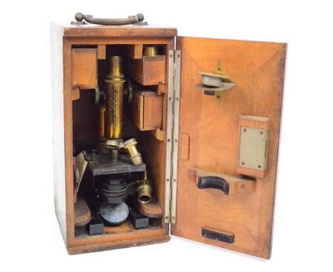 A Leitz brass and black lacquered monocular microscope in wooden case, the base of the instrument numbered 57371, with variou