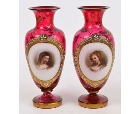 A pair of late 19th century Bohemian ruby glass portrait vases of baluster form, centred with an oval medallion within a gilt