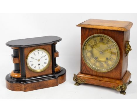 An early 20th century oak cased mantel clock with circular dial set with Roman numerals and gilt metal scrolling feet, height
