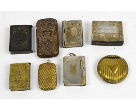 Eight vesta cases; including four book form examples, a brass rounded rectangular example with ribbed decoration, a circular 
