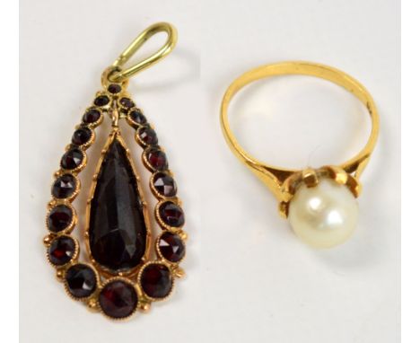 A 9ct yellow gold and cultured pearl ring, size K, and a yellow metal backed garnet pendant (2).