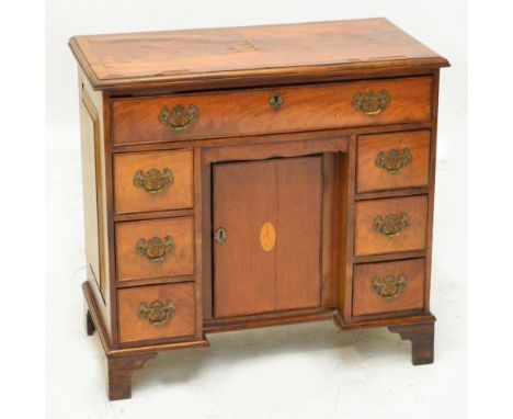 A mahogany and rosewood crossbanded kneehole desk in the George I manner, the moulded rectangular top above frieze drawer, re