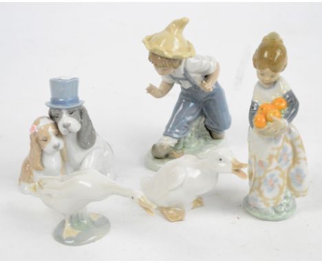 Two Lladro figures; girl holding basket of oranges and a swan, also three Nao figures comprising two puppies, boy with hat an