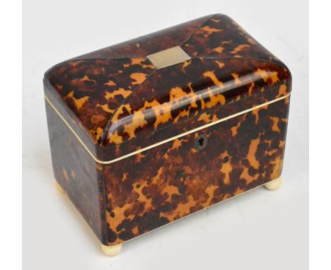 An early 19th century tortoiseshell domed two division tea caddy, the pewter strung hinged lid enclosing two compartments abo