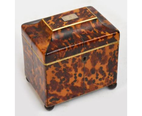 An early 19th century tortoiseshell tea caddy, the pagoda hinged top set with a white metal plaque engraved with the initial 