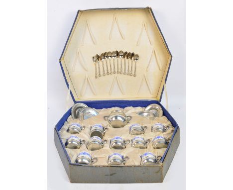 A cased 20th century pewter and ceramic coffee set comprising twelve spoons, twelve blue and white floral decorated cups, twe