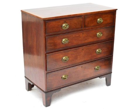 A late George III mahogany boxwood strung and crossbanded chest of drawers, the moulded top above two short and three long gr