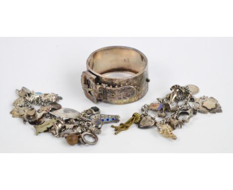 A hallmarked silver wide snap bangle in the form of a buckled belt with a leaf design, a hallmarked silver identity bracelet 