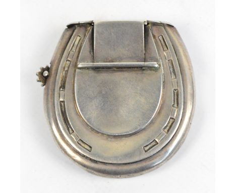 A novelty Victorian hallmarked silver vesta case modelled as a horseshoe, the hinged lid enclosing the striking surface and t