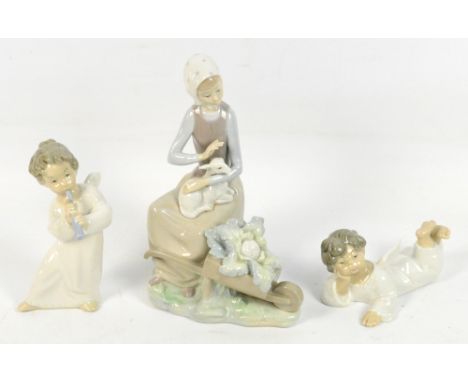 Three Lladro figures; a girl with a lamb and a cauliflower in a barrow, height 23.5cm, an angel playing a pipe, and a reclini