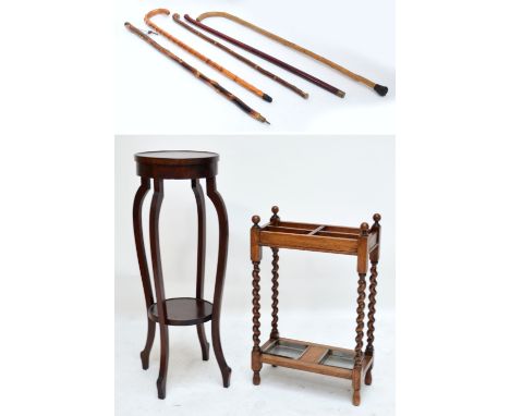 A 1920s oak four section stick stand, five various sticks and an Edwardian two tier jardinière stand.