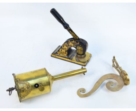 A late 19th century John Linwood brass spit with an associated brass wall mounted bracket and a gilt decorated stamp (3).