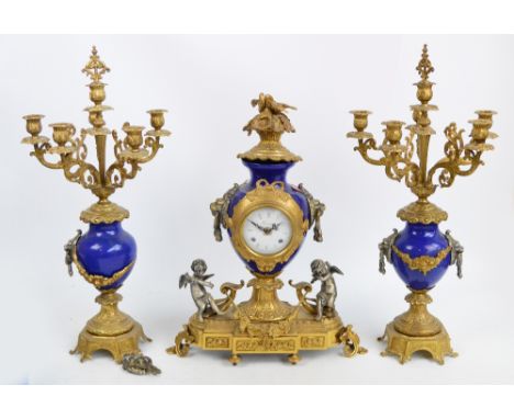 A modern decorative gilt metal mounted porcelain clock garniture, the central timepiece with circular white enamel dial set w