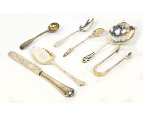 A George VI hallmarked silver sifting spoon, Sheffield 1937, a pair of silver sugar tongs, a silver scoop spoon, a mustard sp