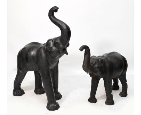 A large leather covered model of an Indian elephant with his trunk raised (no tusks), height 86cm to tip of trunk and a simil