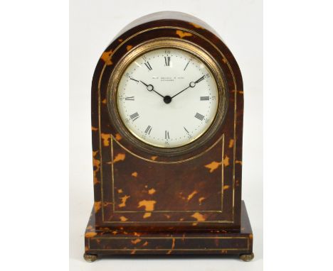 A late 19th century tortoiseshell and silver string inlaid mantel timepiece with curved top and raised on rectangular plinth 