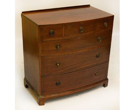 A reproduction mahogany bowfronted chest of drawers, the shaped top above three short and three long graduated drawers on squ
