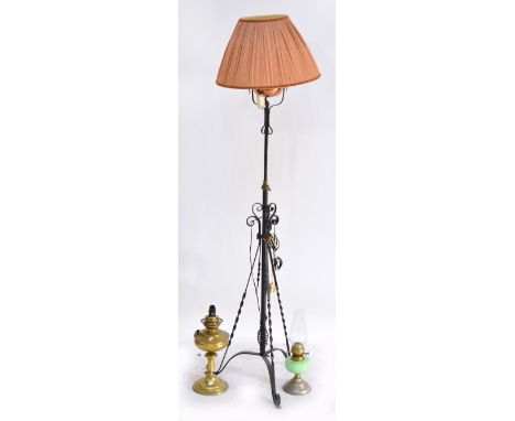 A wrought iron standard electric lamp in the form of a copper oil lamp with adjustable height, a table lamp converted from a 
