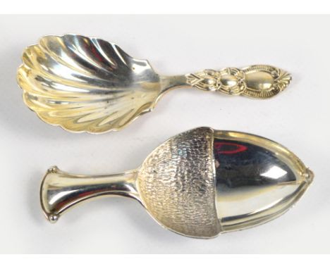 A George V hallmarked silver caddy spoon modelled as an acorn, Thomas Bradbury & Sons Ltd, Sheffield 1912, length 8cm, and a 