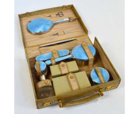 A small vellum lady's dressing case fitted with George VI hallmarked silver mounted and pale blue guilloche enamel contents c