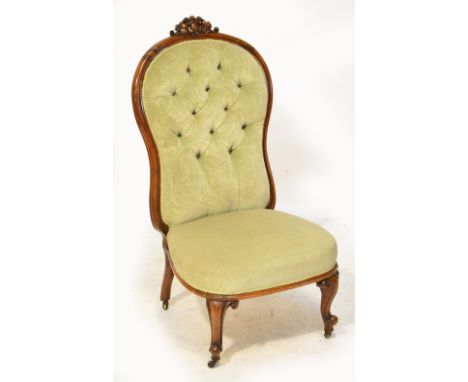 A Victorian walnut framed button back upholstered side chair with padded seat and cabriole front legs.