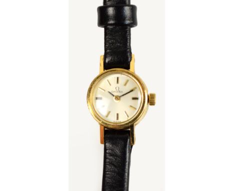 A vintage lady's Omega 9ct gold cased manual wind wristwatch with circular dial set with baton numerals, on black leather str