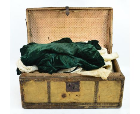 A vellum covered domed trunk containing a quantity of 19th century and later textiles to include a Victorian velvet child's d