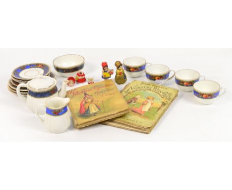 A doll's tea service including teapot, jug and bowl, cups, saucers and plates, three small ceramic dolls (one af), and two Fr