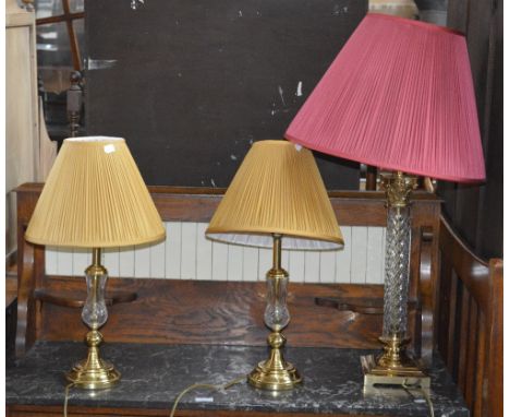 A contemporary cut glass and brass mounted Corinthian column table lamp and two cut glass and brass smaller examples (3).
