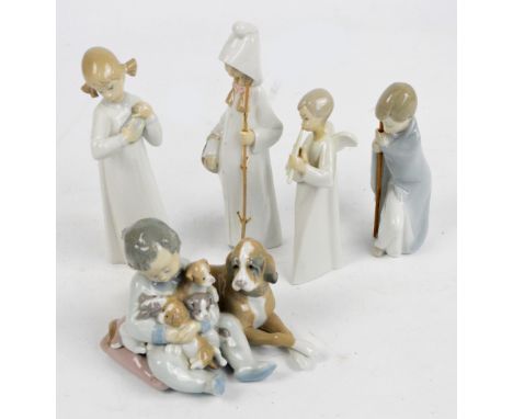 Four Lladro figures; child seated holding puppies beside a dog, two figures of young girls, a child holding a staff and a Nao