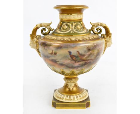 A large Royal Worcester gilt heightened twin handled vase, the flared neck above scrolling border and pierced mask adorned sc