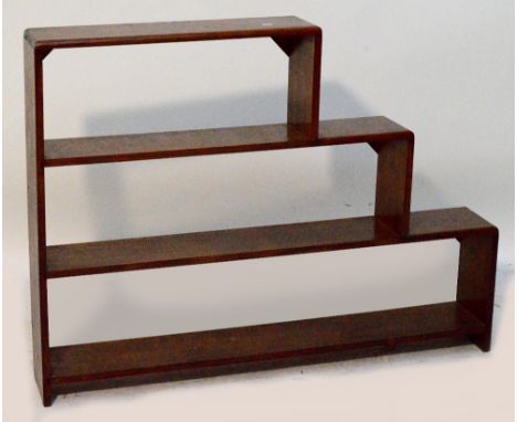 An oak three shelf open bookcase with stepped tiers, width 127cm, height 90cm.