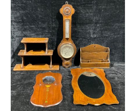 An oak wall hanging aneroid wheel barometer, with thermometer, 62cm; an Edwardian inlaid mahogany hall mirror; another simila