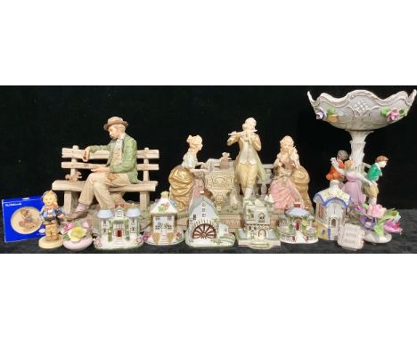 A German porcelain pedestal table centre, pierced basket printed with flowers, the support with dancing figures in relief, 33