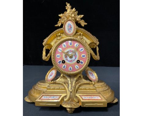 A 19th century French gilt mantel clock, set with porcelain panels, eight day movement, H T Brevet 