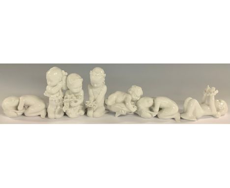 A set of seven Danish Bing and Grøndahl merchildren figures, each glazed in gloss white, in various poses, kneeling with star