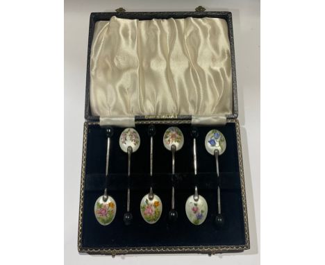 A set of six silver plated and enamel coffee spoons, each decorated in polychrome with English country garden flowers on a wh