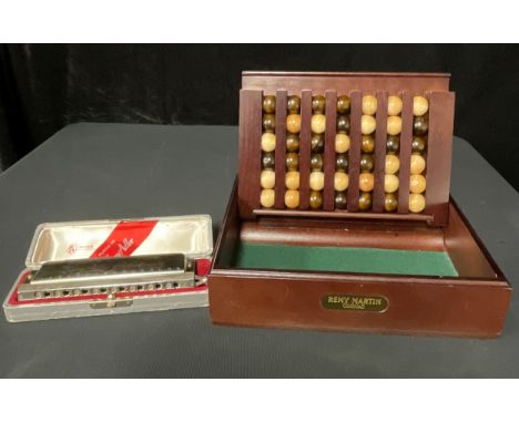 A Larry Adler harmonica, boxed; a Remy Martin promotional "connect four" game (2) 