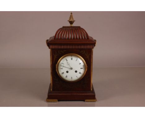 A 20th century Regeny style mantle clock, 39cm high, with brass inlay and applied finial and handles, with brass grills to si