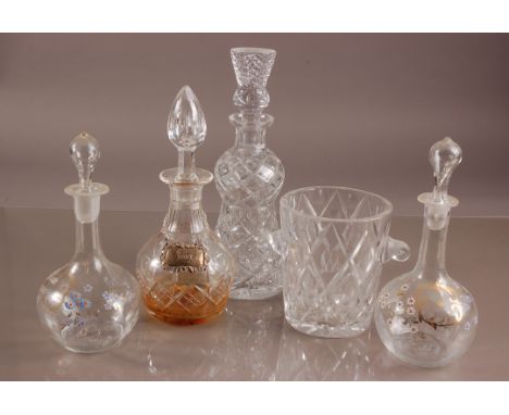 Four Victorian and later glass decanters and a cut glass ice bucket, including a pair with painted enamel flowers, another wi