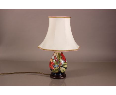A modern Moorcroft pottery lamp base, Hibiscus pattern in bright colours, with shade 