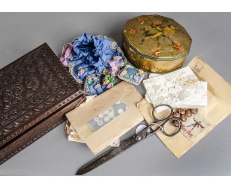 A collection of buttons, gloves and textiles, first half 20th century, the buttons in a wooden carved box 