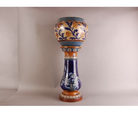 A late Victorian Doulton stoneware jardninere and stand, 75cm, the floral decoration planter cracked to base, and having an a