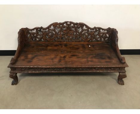A second half 20th century Indian carved wood low bench, 126cm wide 