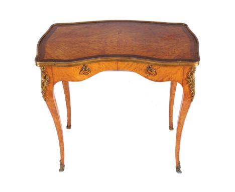 NINETEENTH-CENTURY ORMOLU MOUNTED SATINWOOD LADIES WRITING TABLE, CIRCA 1890the inverted breakfront serpentine shaped top, ab