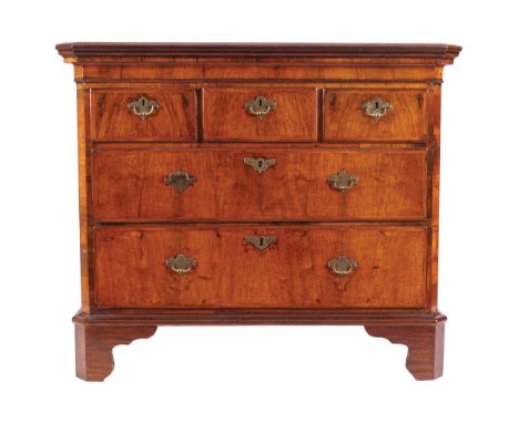 EIGHTEENTH-CENTURY WALNUT PERIOD CHESTof three short and three long drawers, furnished armorial brass handles and escutcheons