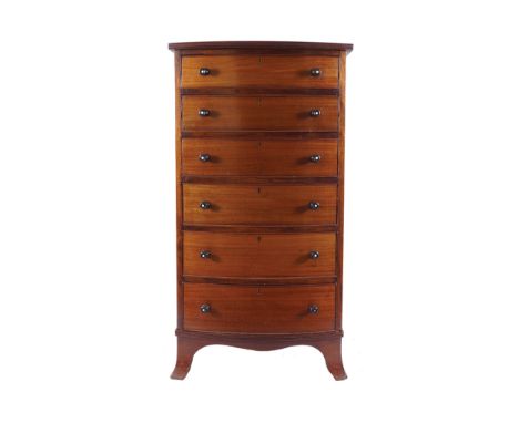 EDWARDIAN MAHOGANY BOW FRONT TALL BOYof six long drawers, furnished with ebony handles, raised on out-swept ogee bracket feet