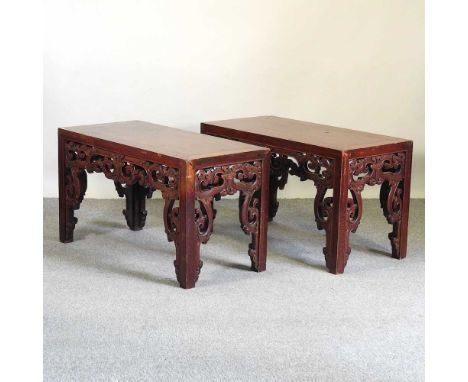 A pair of Chinese rosewood opium tables, each of rectangular shape, on an ornate scroll carved baseeach 104w x 50d x 60h cm